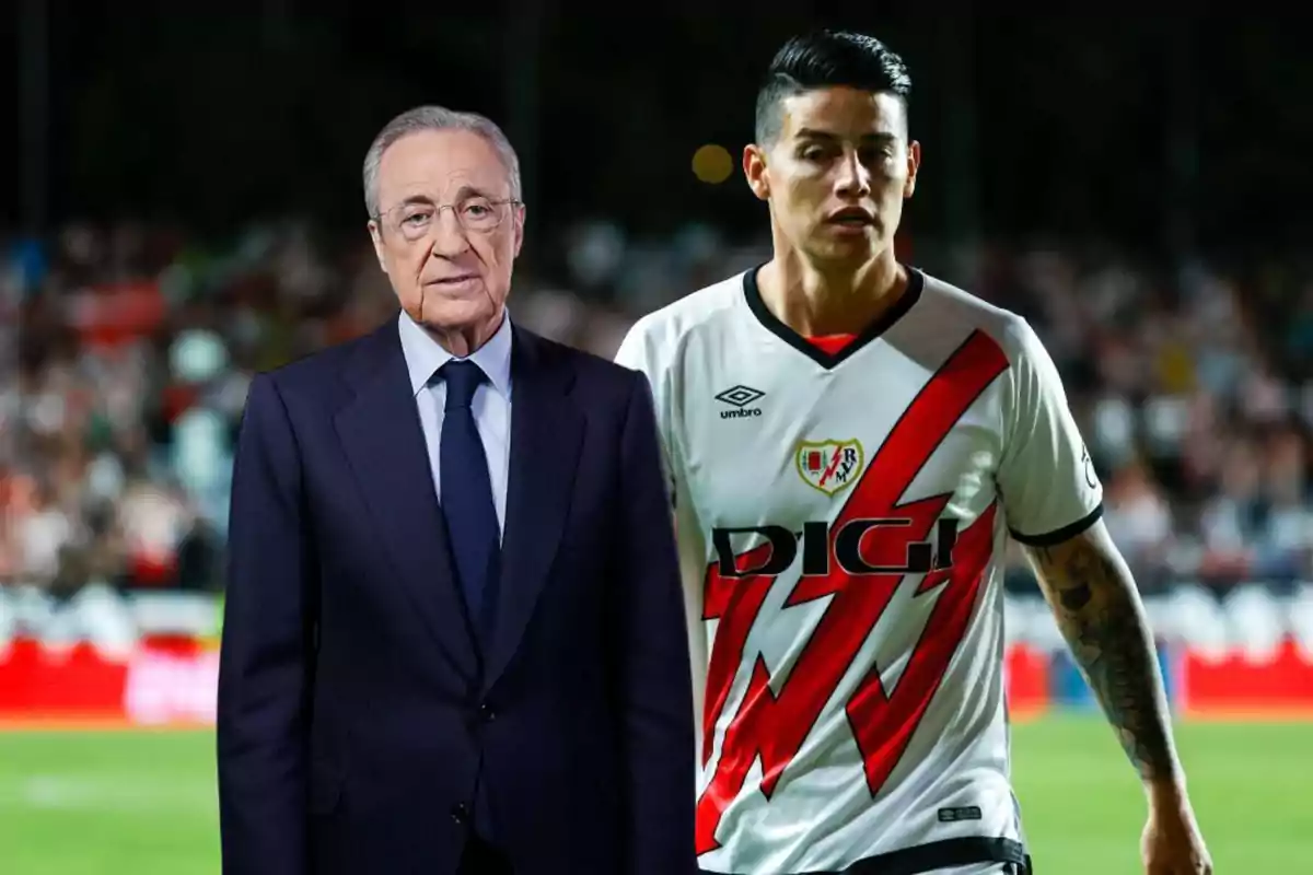 An older man in a suit standing next to a soccer player in a white and red uniform in a stadium.