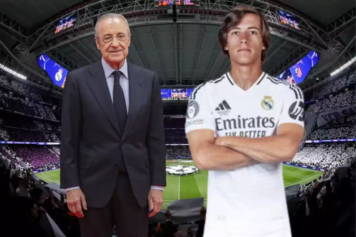 Dos personas posan en un estadio de fútbol lleno de espectadores, una lleva un traje formal y la otra un uniforme de fútbol blanco.