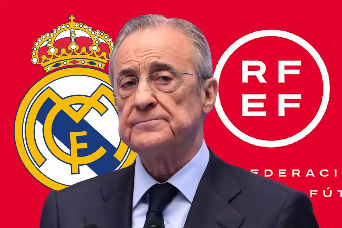 Un hombre con traje frente a los logotipos del Real Madrid y la RFEF sobre un fondo rojo.