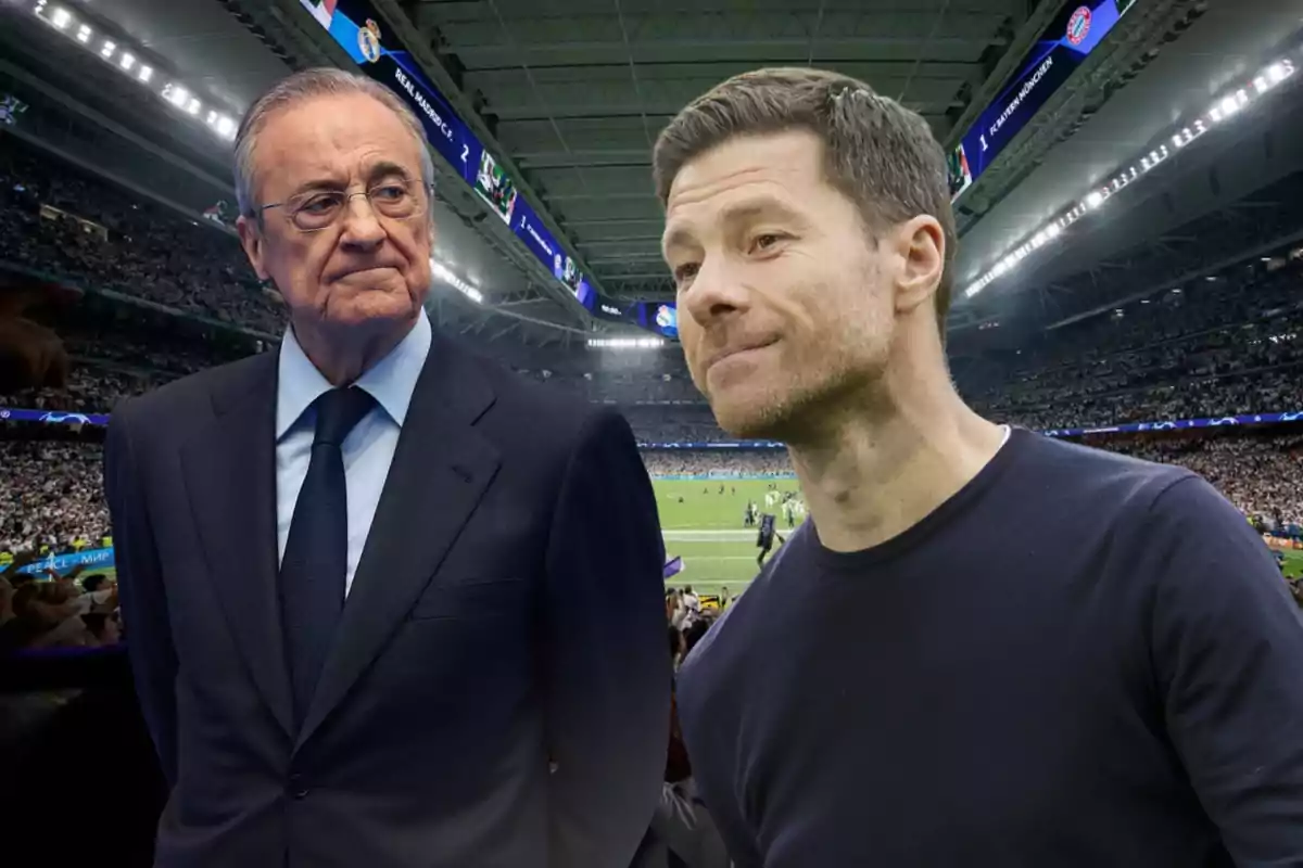 Two men in the foreground inside a soccer stadium full of spectators