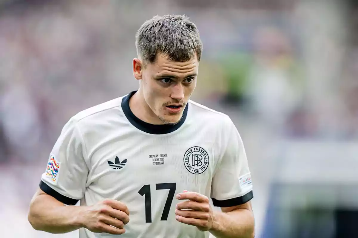 Soccer player wearing the white Germany national team jersey with the number 17 during a match Soccer player wearing the white Germany national team jersey with the number 17 during a match