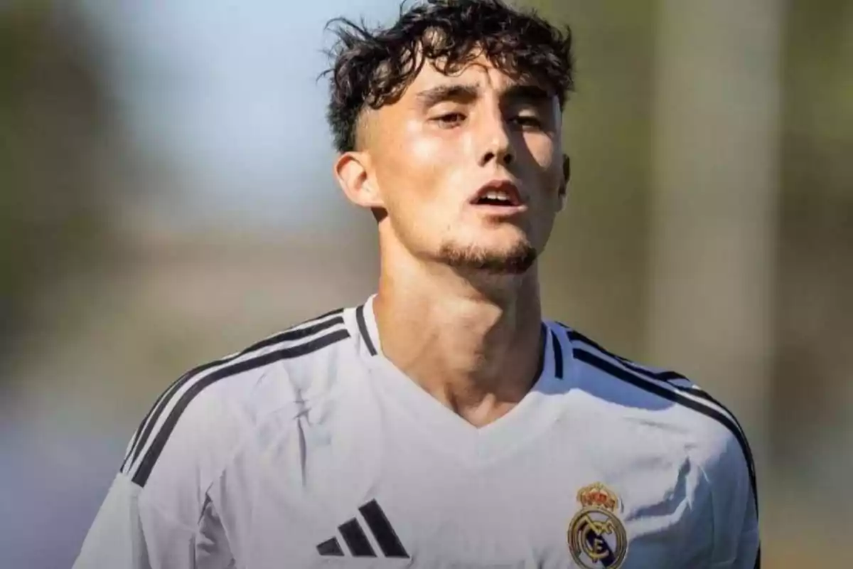 A soccer player in a white Real Madrid jersey on the field. A soccer player in a white Real Madrid jersey on the field.