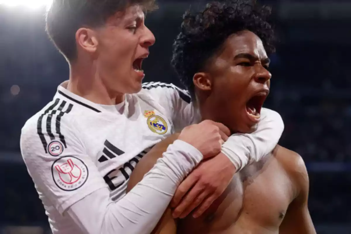 Two soccer players enthusiastically celebrating a goal in a Real Madrid match. Two soccer players enthusiastically celebrating a goal in a Real Madrid match.