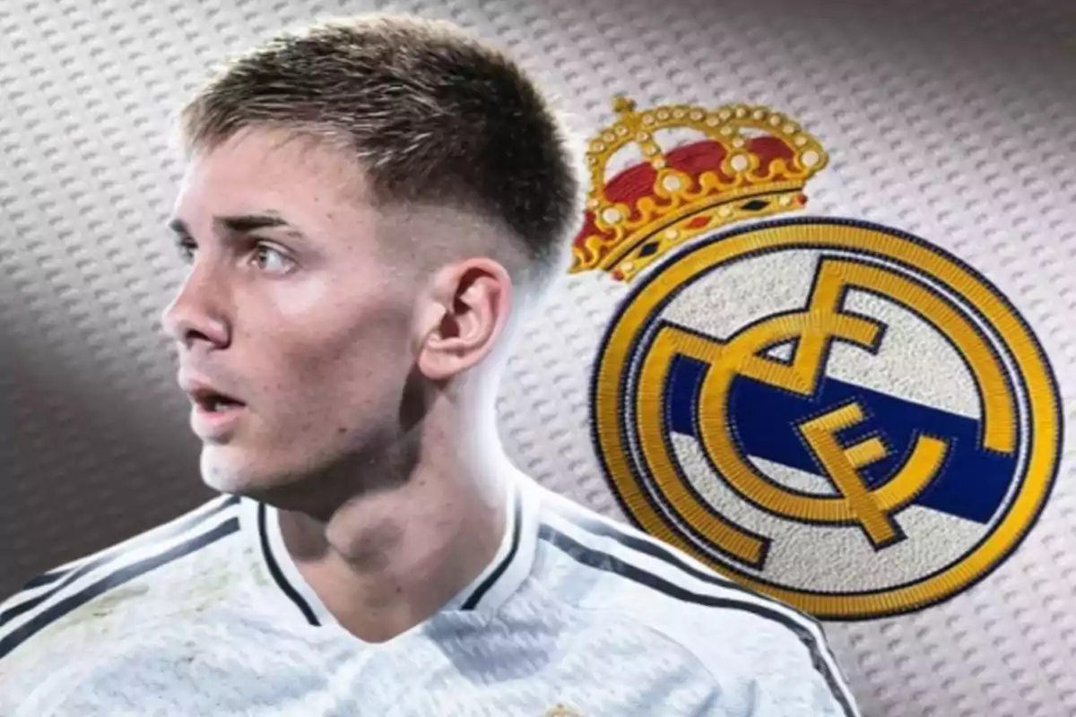 Un futbolista con camiseta blanca mira hacia la izquierda con el escudo del Real Madrid al fondo.