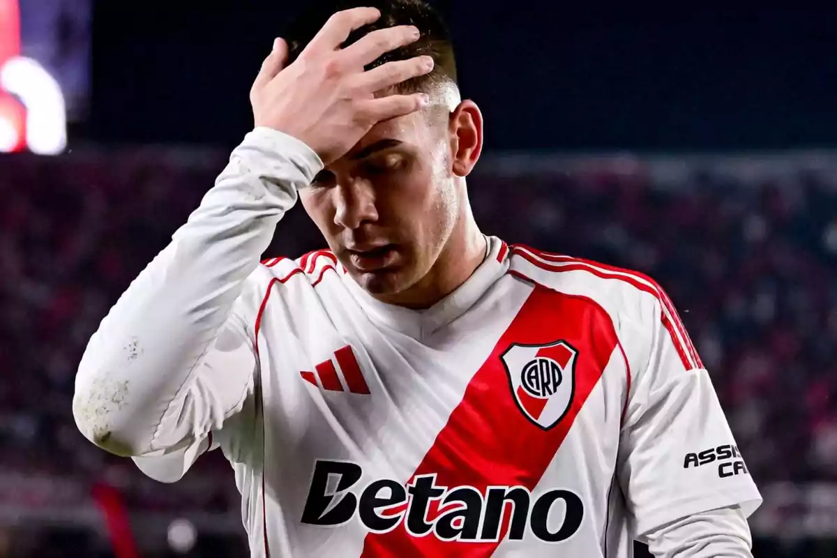 River Plate player with a frustrated expression holding his head during a match River Plate player with a frustrated expression holding his head during a match