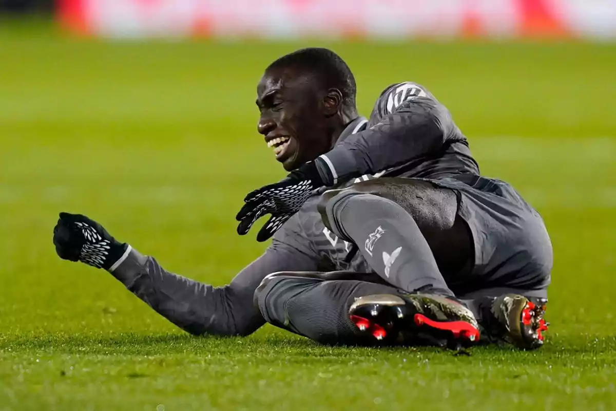 Soccer player on the ground with pain expression during a match. Soccer player on the ground with pain expression during a match.