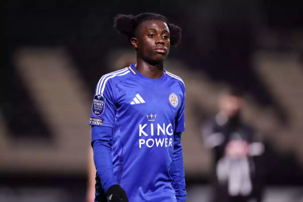 Un jugador de fútbol con el uniforme azul del Leicester City está en el campo durante un partido. Un jugador de fútbol con el uniforme azul del Leicester City está en el campo durante un partido.