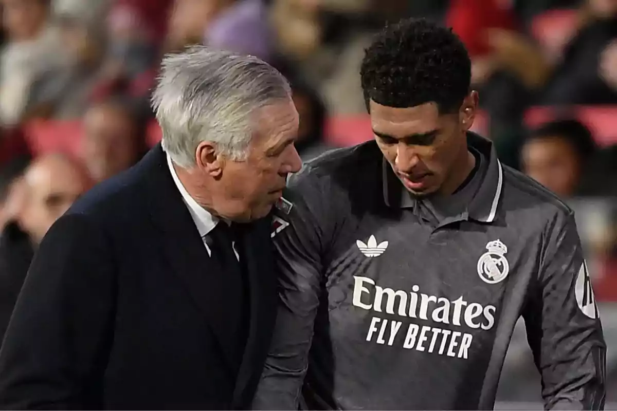 A soccer coach talks to a Real Madrid player during a match. A soccer coach talks to a Real Madrid player during a match.