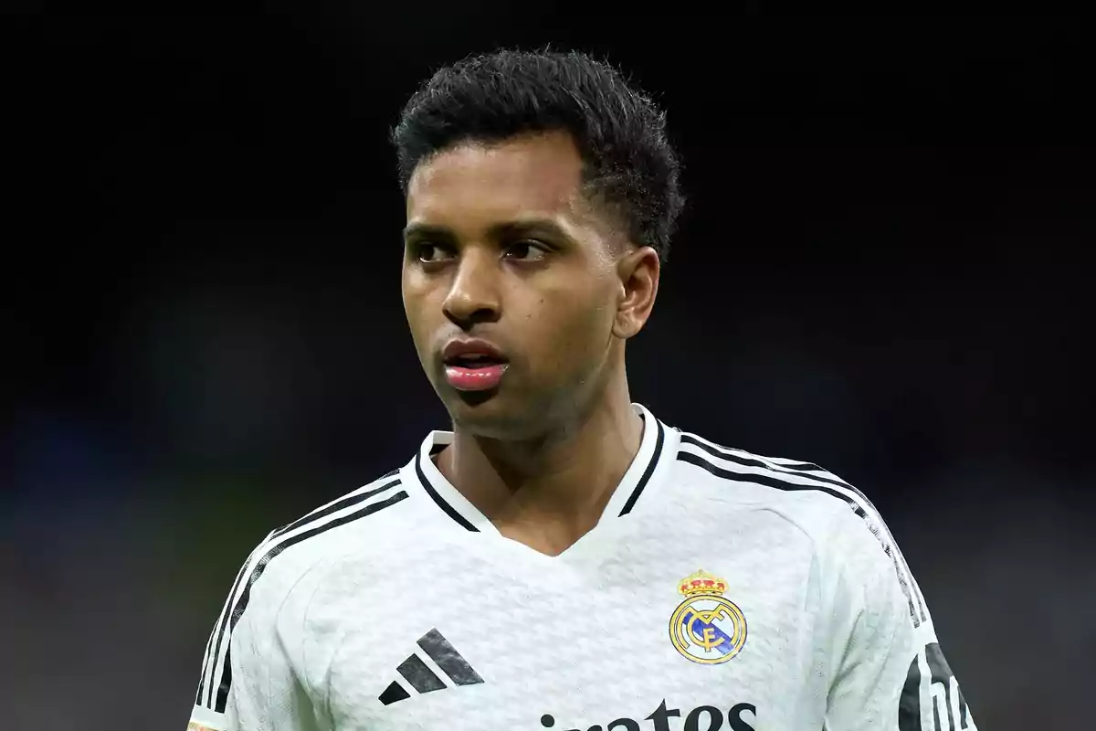 Soccer player in a white Real Madrid jersey on the field.