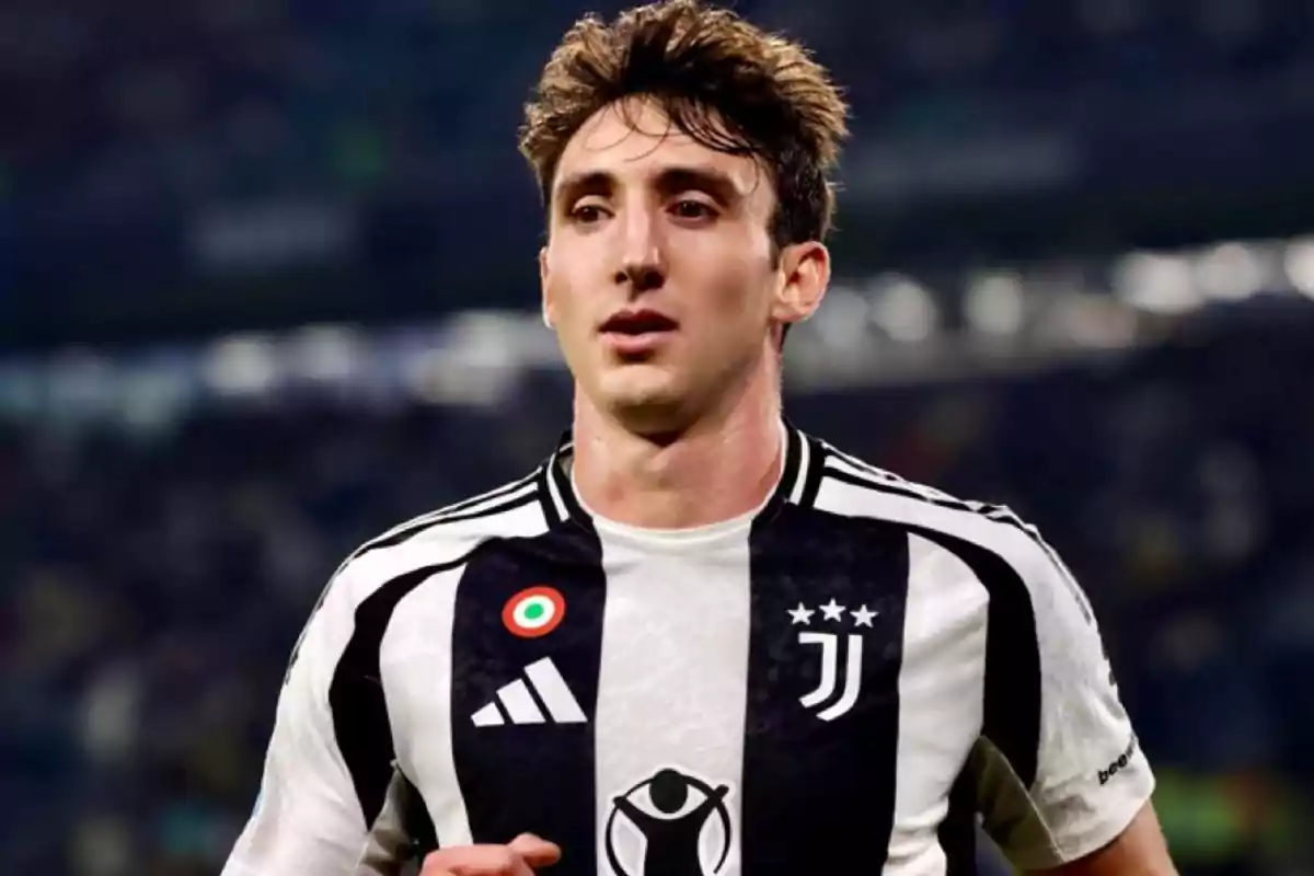 A player in a Juventus uniform on the field. A player in a Juventus uniform on the field.