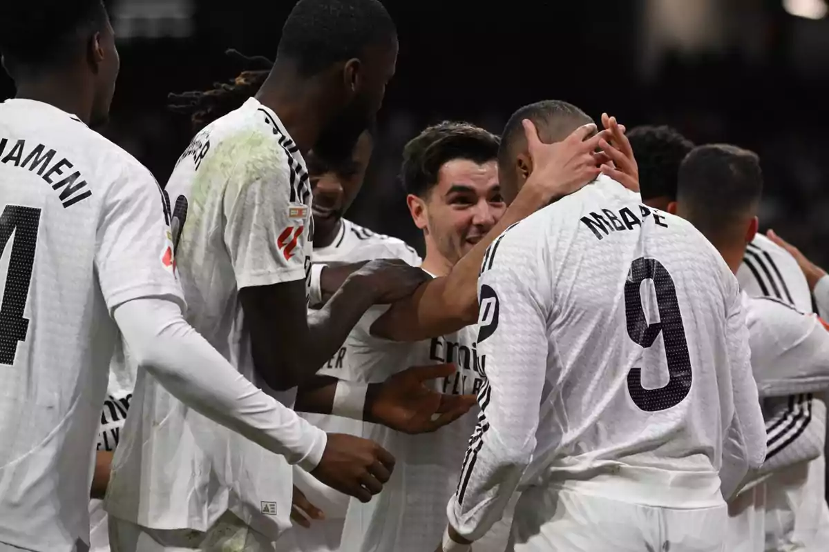 Soccer players celebrating a goal on the field.