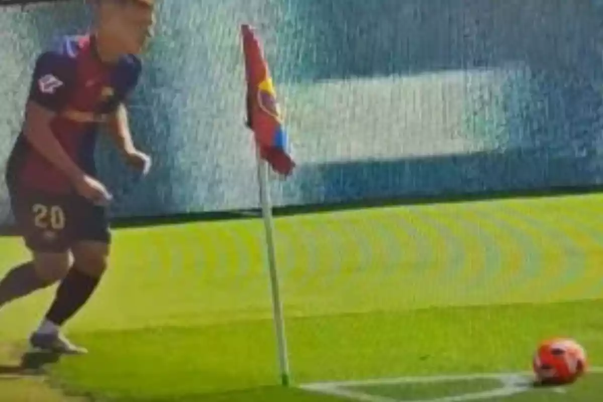 Soccer player preparing to take a corner kick on a playing field.