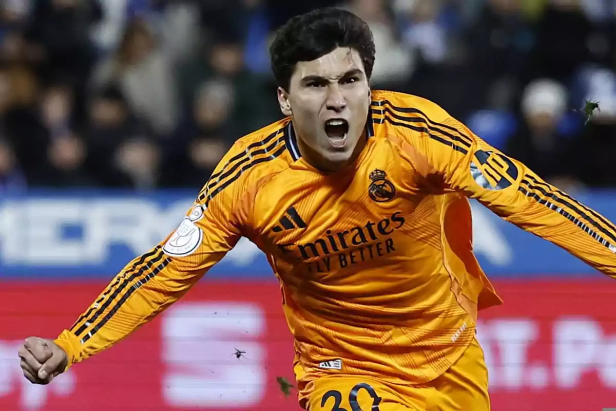 Real Madrid goalkeeper celebrating effusively during a soccer match in an orange uniform Real Madrid goalkeeper celebrating effusively during a soccer match in an orange uniform