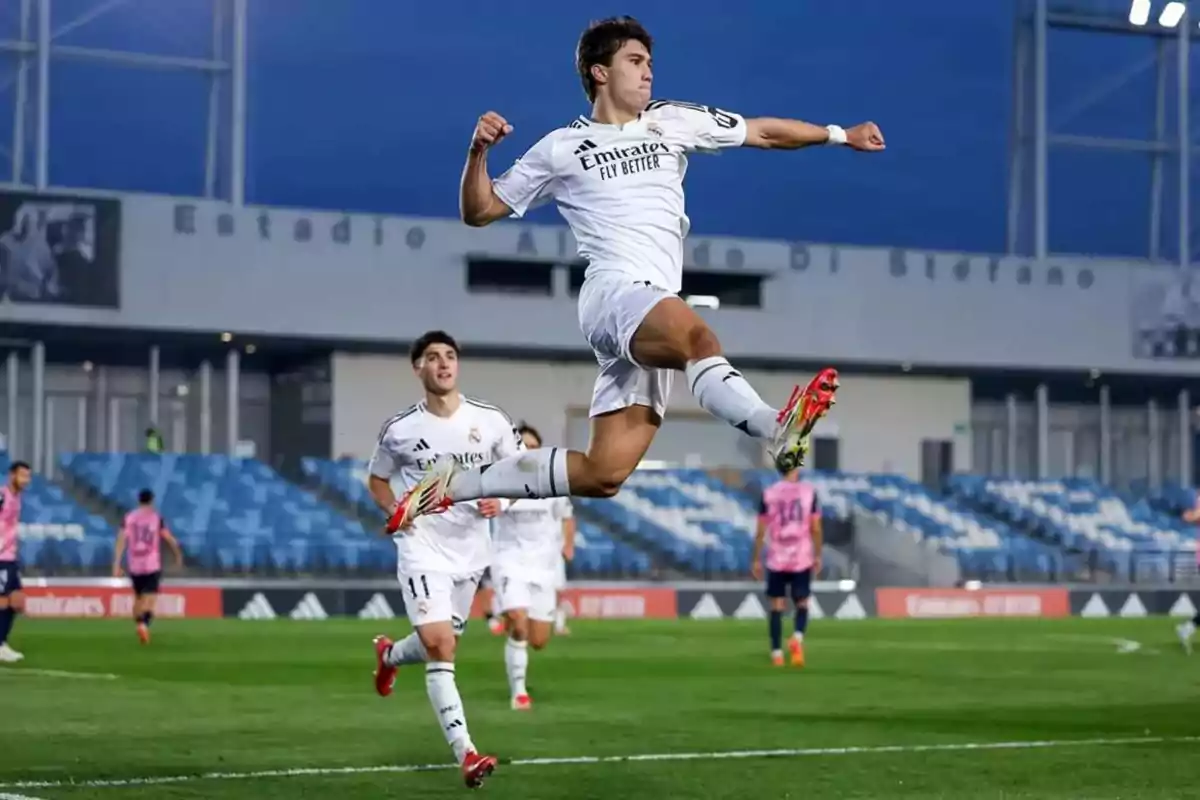 A player from Real Madrid jumps in the air celebrating a goal at the Alfredo Di Stéfano Stadium.