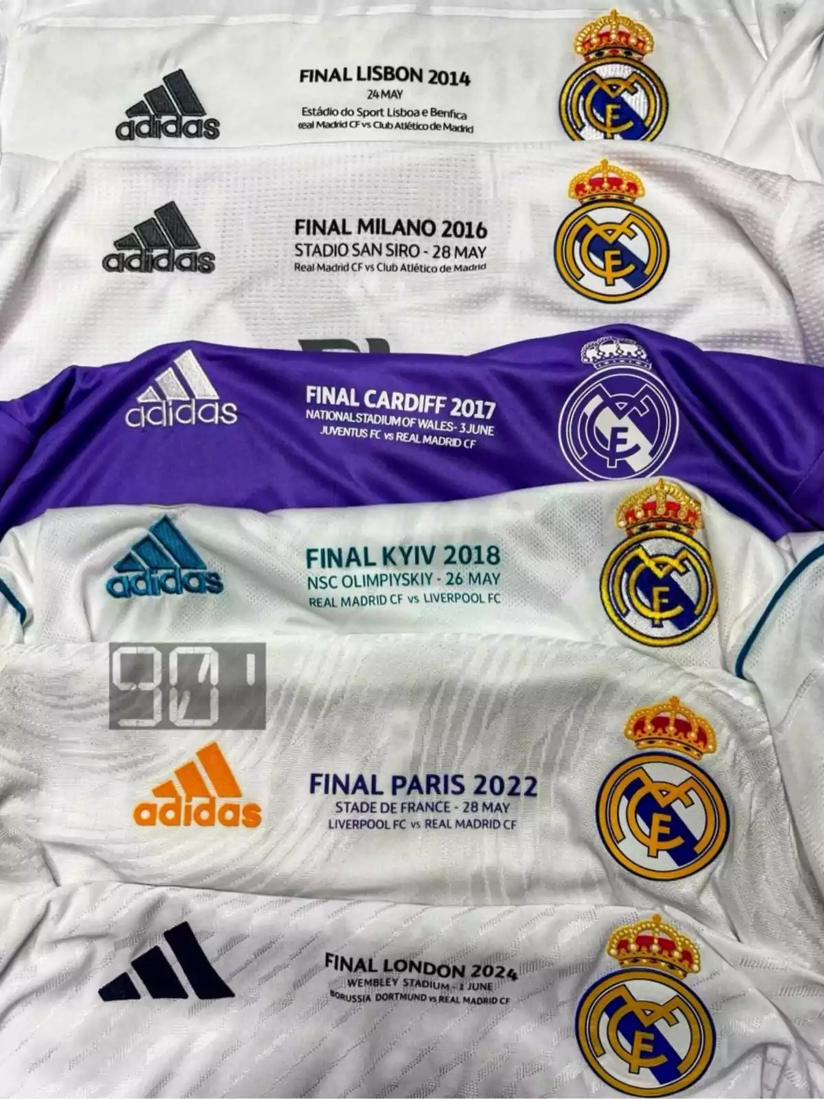 Real Madrid soccer jerseys with details from the UEFA Champions League finals of the years 2014, 2016, 2017, 2018, 2022, and 2024, featuring the Adidas logo and the club's crest. Real Madrid soccer jerseys with details from the UEFA Champions League finals of the years 2014, 2016, 2017, 2018, 2022, and 2024, featuring the Adidas logo and the club's crest.