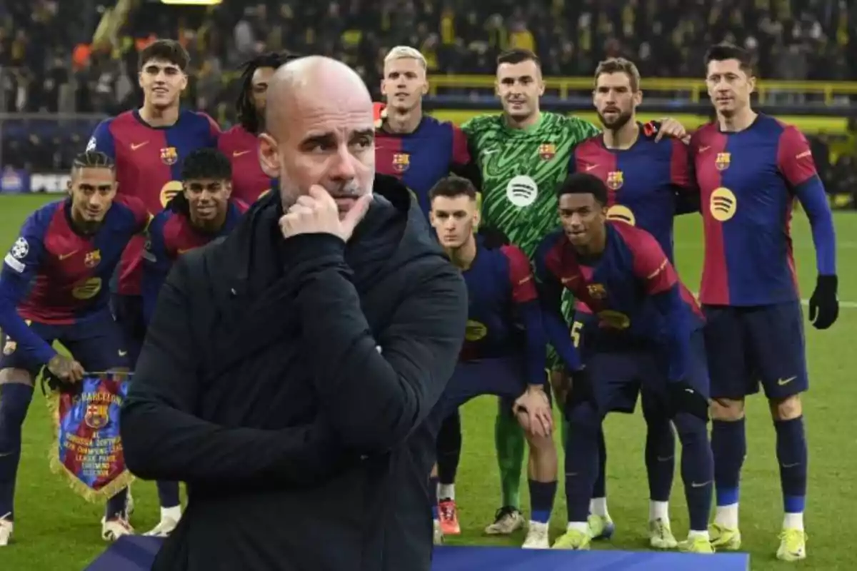 A group of soccer players in blue and red uniforms pose for a photo on the field, while a man in a black jacket appears in the foreground with a thoughtful expression.