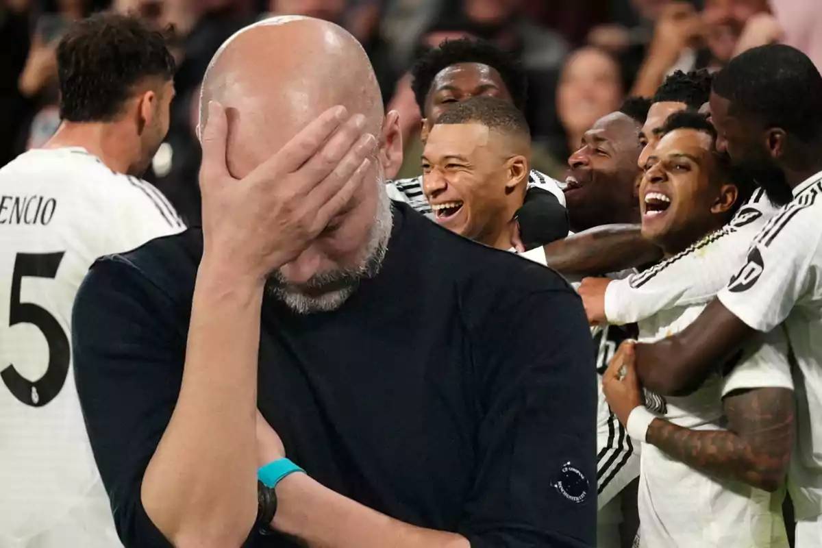 A man with his hand on his face while a group of players celebrates behind him.