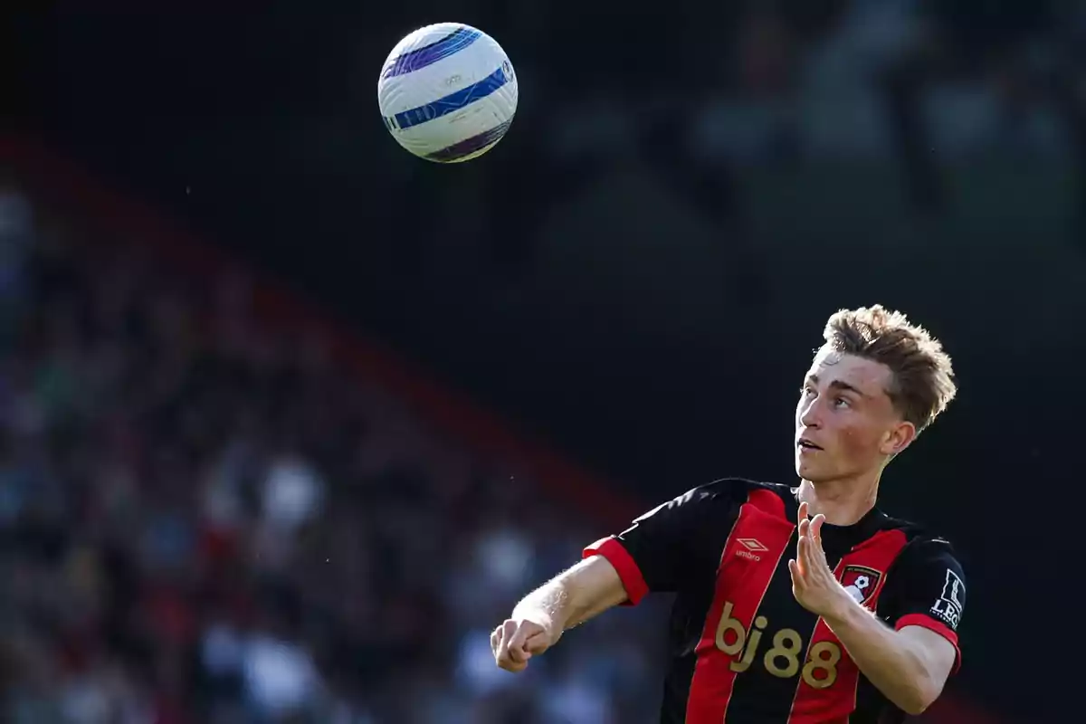 A player watches a ball in the air during a match. A player watches a ball in the air during a match.