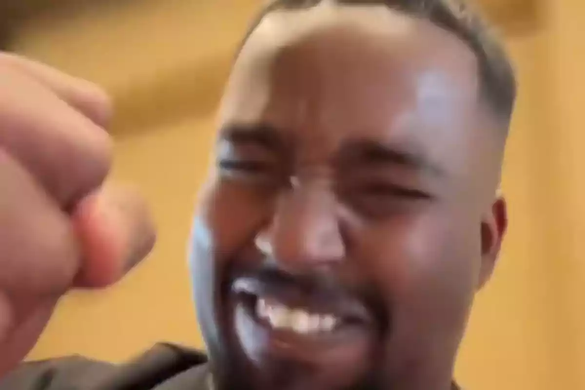 Person smiling with fist raised in celebration. Person smiling with fist raised in celebration.