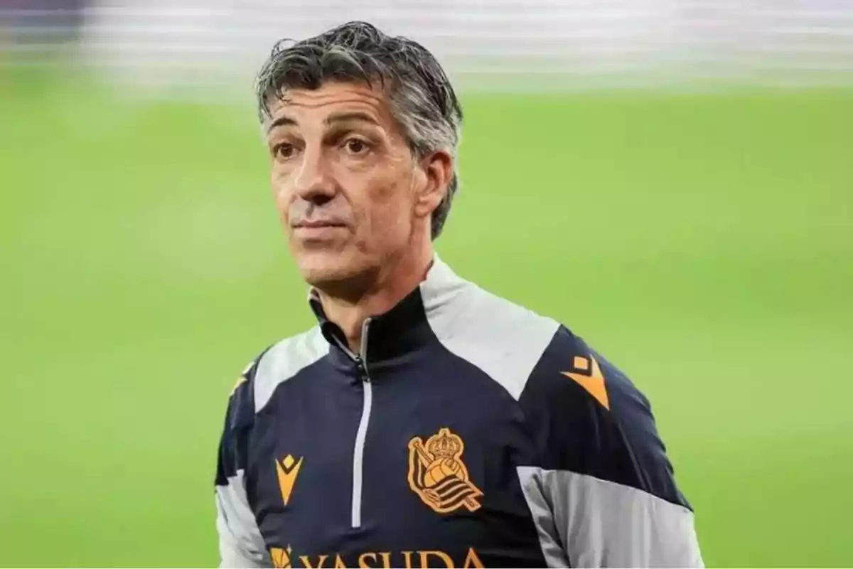 Man wearing a Real Sociedad sports jacket on a soccer field. Man wearing a Real Sociedad sports jacket on a soccer field.
