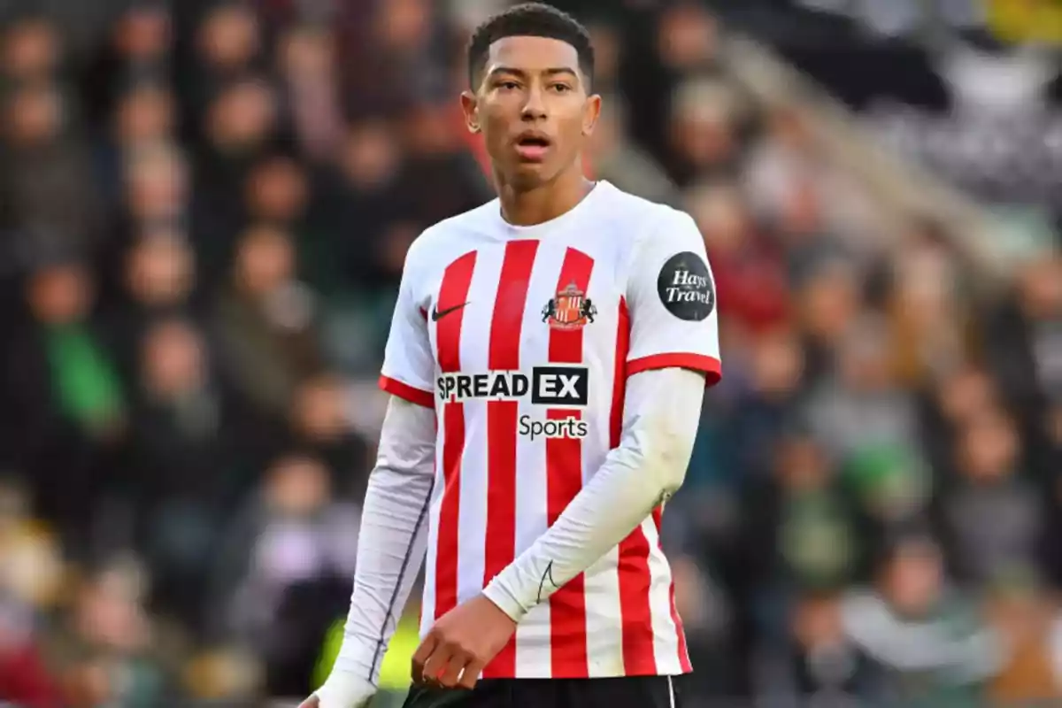 Soccer player in red and white striped uniform on the field. Soccer player in red and white striped uniform on the field.