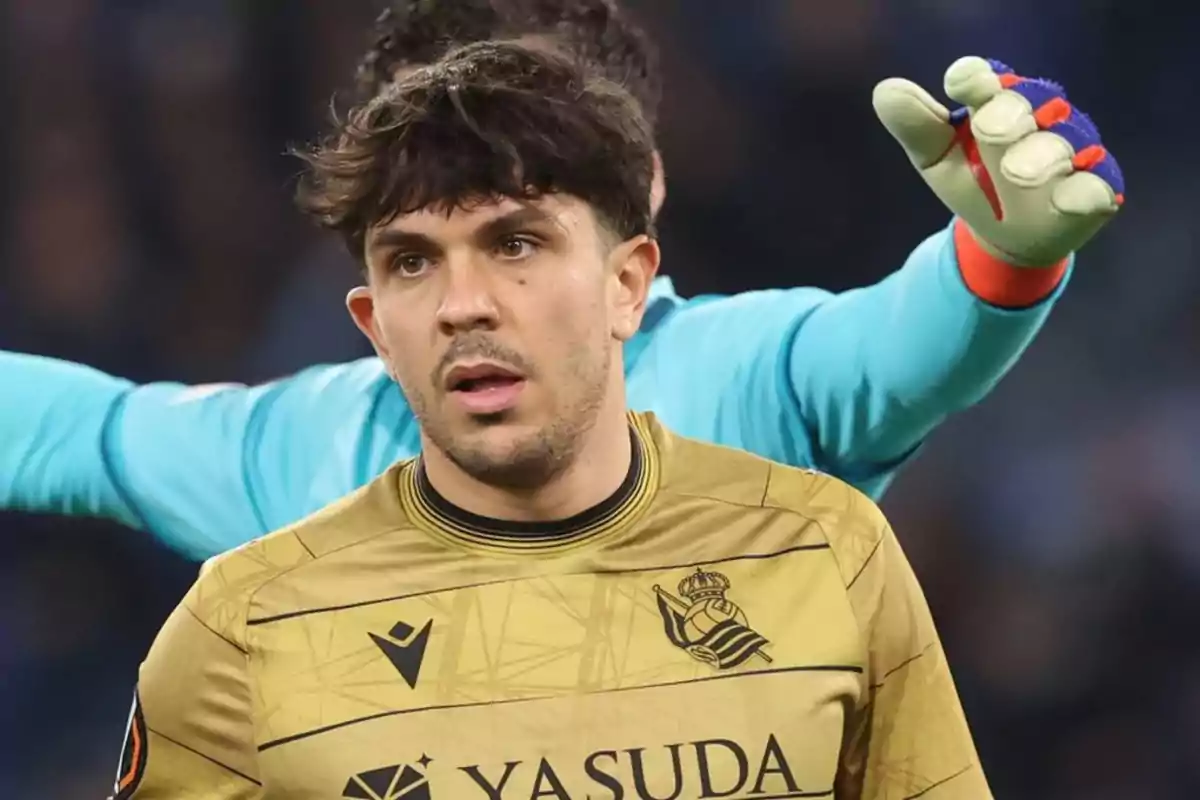 A player in a golden uniform on the field, with a goalkeeper behind. A player in a golden uniform on the field, with a goalkeeper behind.