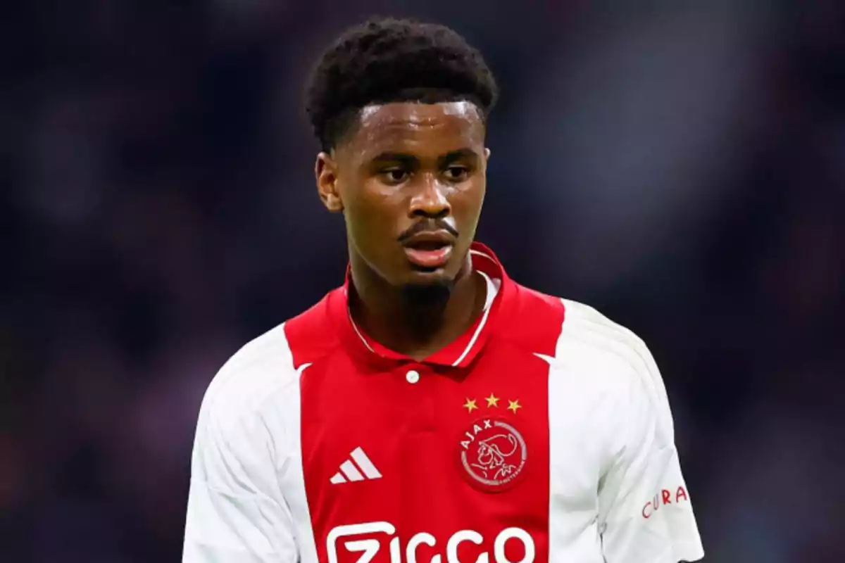 A player in an Ajax uniform on the field. A player in an Ajax uniform on the field.