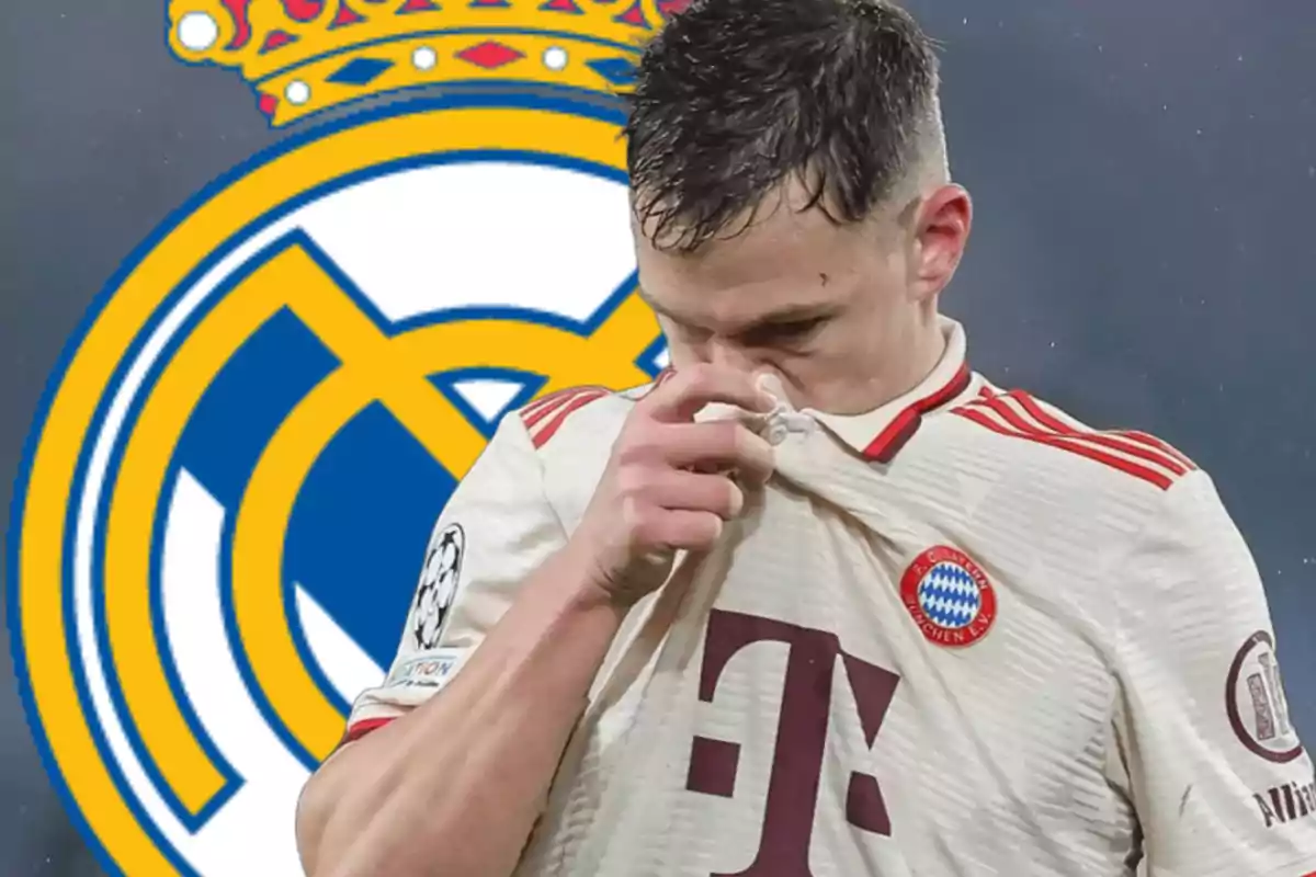 A Bayern Munich player covers his face with his jersey as the Real Madrid crest is seen in the background.