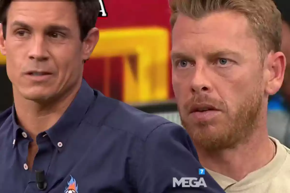 Two men on a television set with serious expressions and the MEGA logo in the bottom right corner