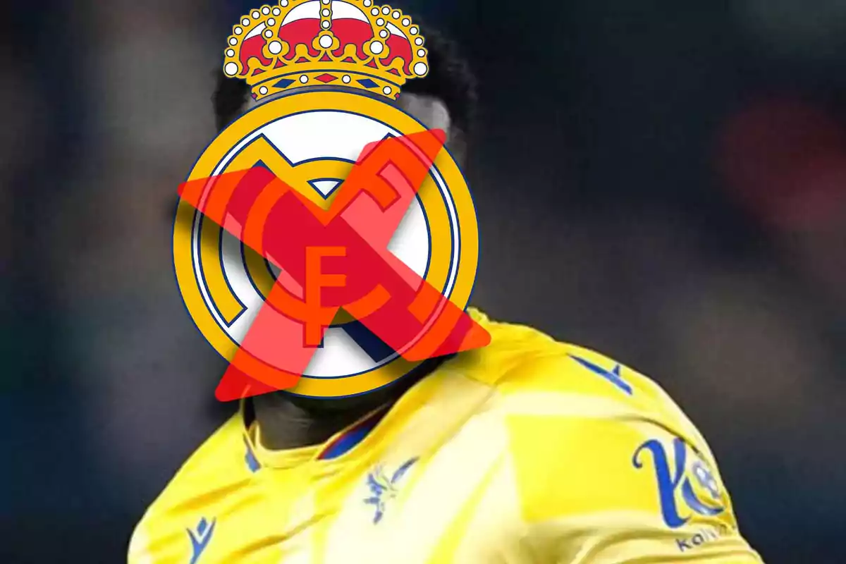 Player in a yellow uniform whose face is covered by the Real Madrid crest crossed out with a red X