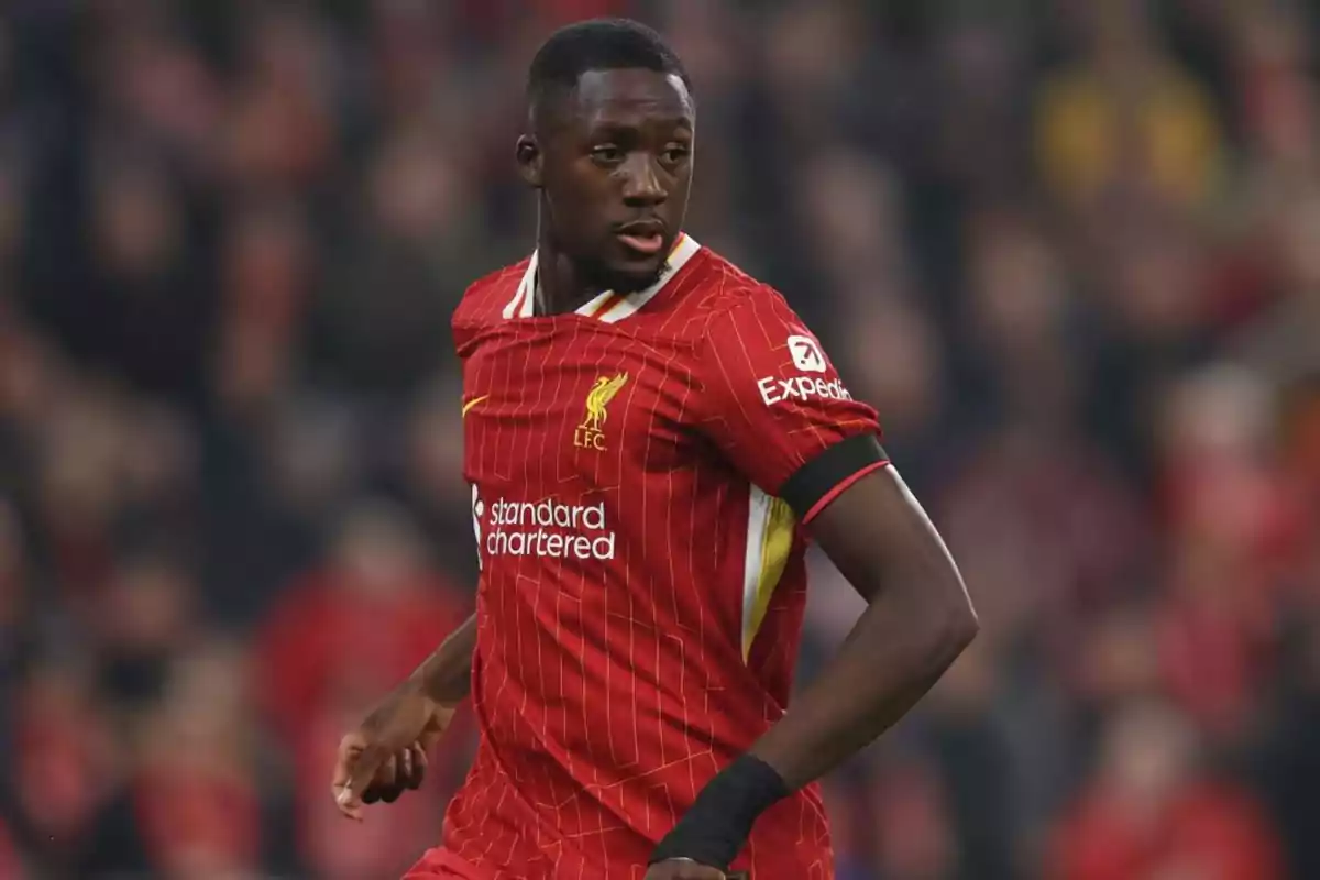 A player in a red uniform on the playing field. A player in a red uniform on the playing field.