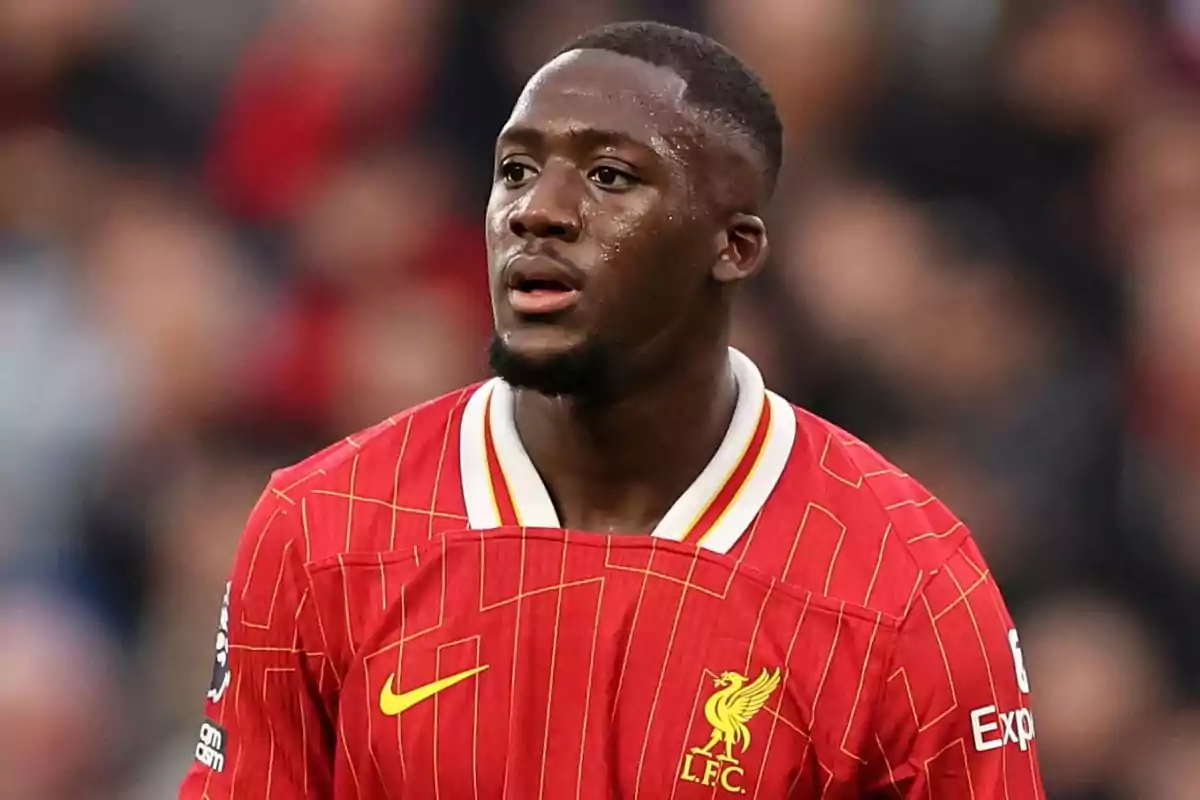 Liverpool player in a red jersey on the field. Liverpool player in a red jersey on the field.