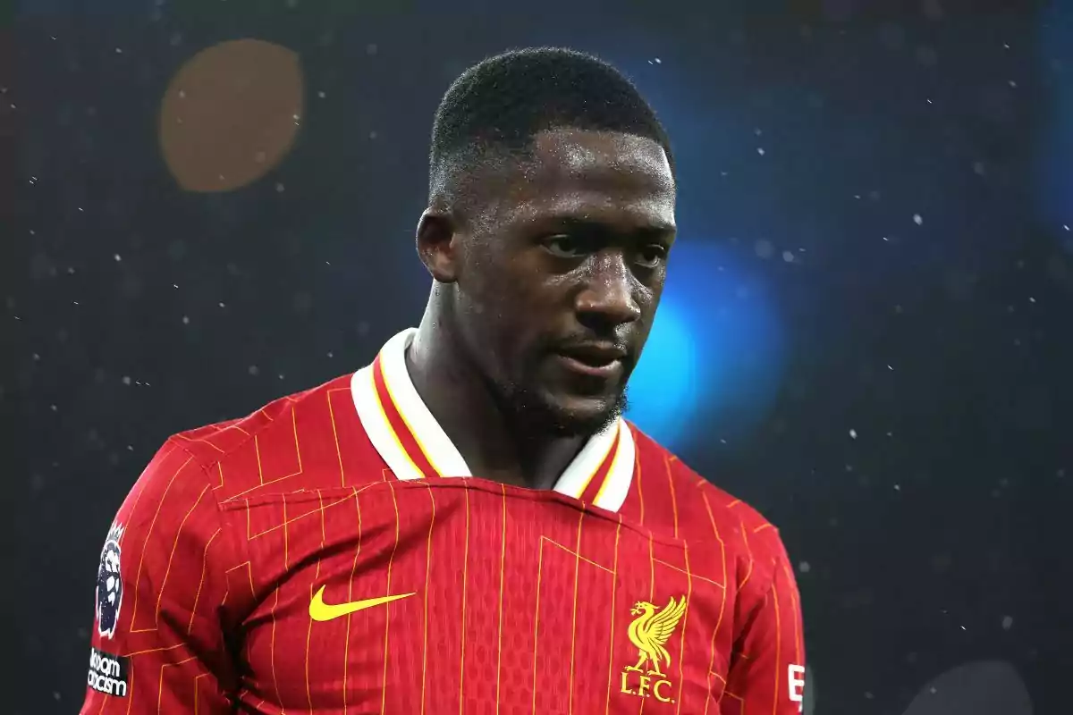 A player in the red uniform of Liverpool FC on a playing field. A player in the red uniform of Liverpool FC on a playing field.