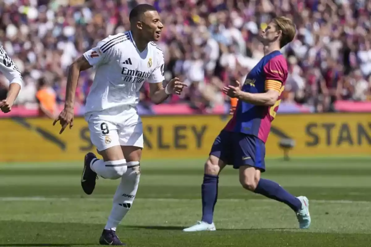 Two players in action during a match, one in a white uniform and the other in a blue and red uniform, in a stadium full of spectators.