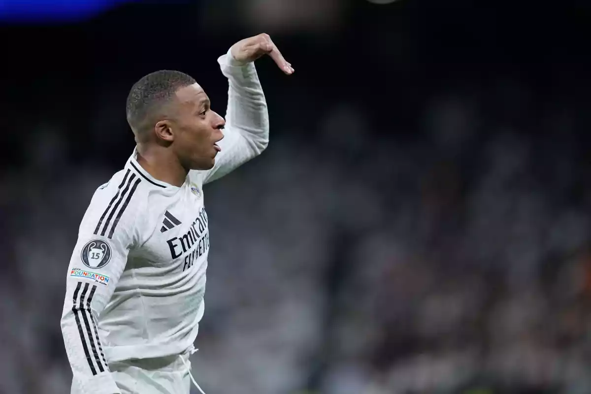 Soccer player in a white uniform celebrating in a stadium during a match Soccer player in a white uniform celebrating in a stadium during a match