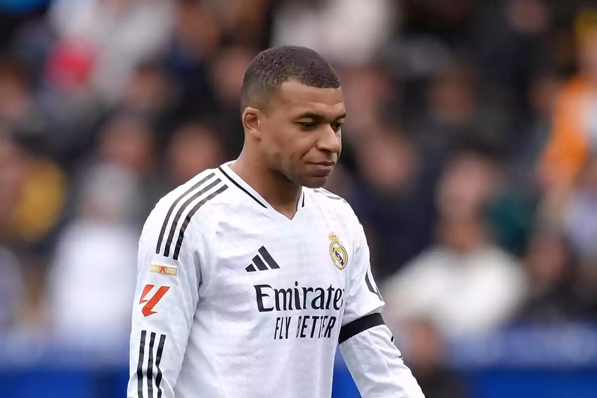 Futbolista con uniforme blanco del Real Madrid en el campo durante un partido Futbolista con uniforme blanco del Real Madrid en el campo durante un partido