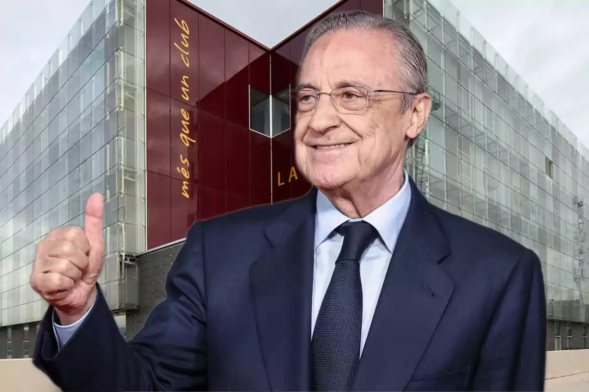 A man in a suit smiles and gives a thumbs up in front of a modern building with the phrase "més que un club."