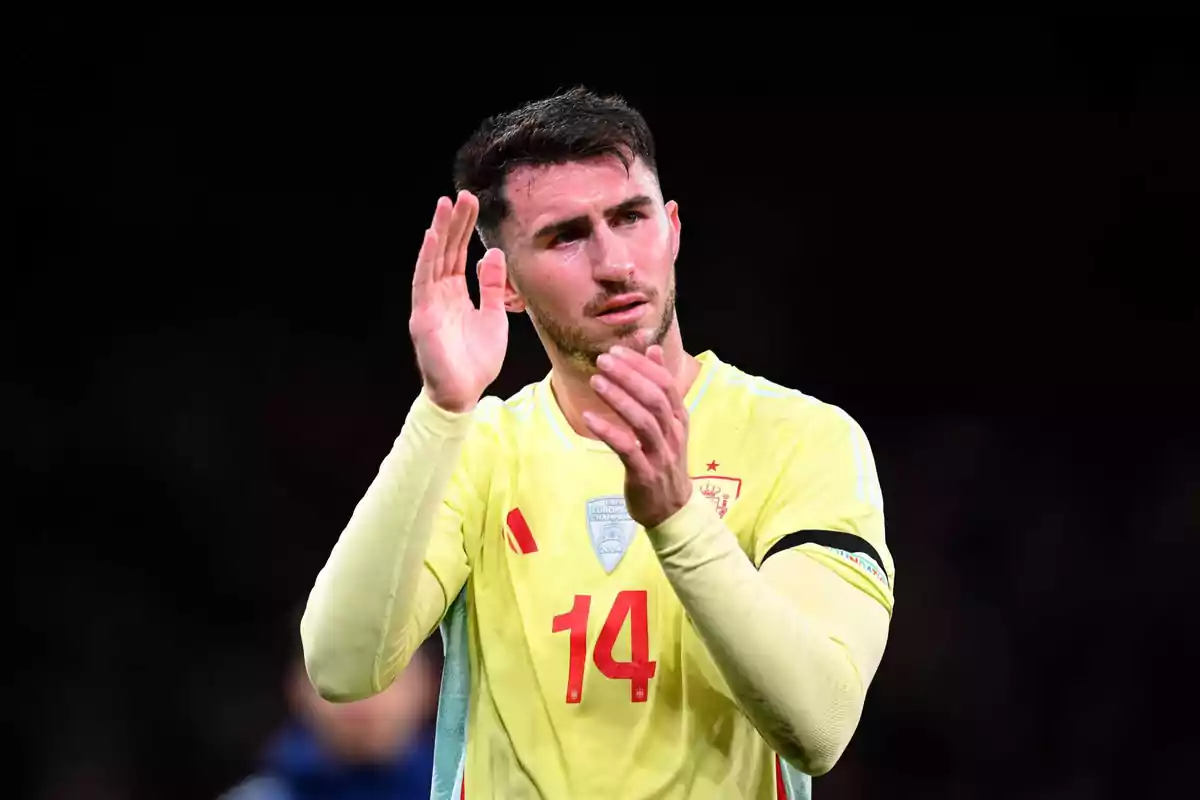 Soccer player applauding on the field in yellow uniform with number 14. Soccer player applauding on the field in yellow uniform with number 14.