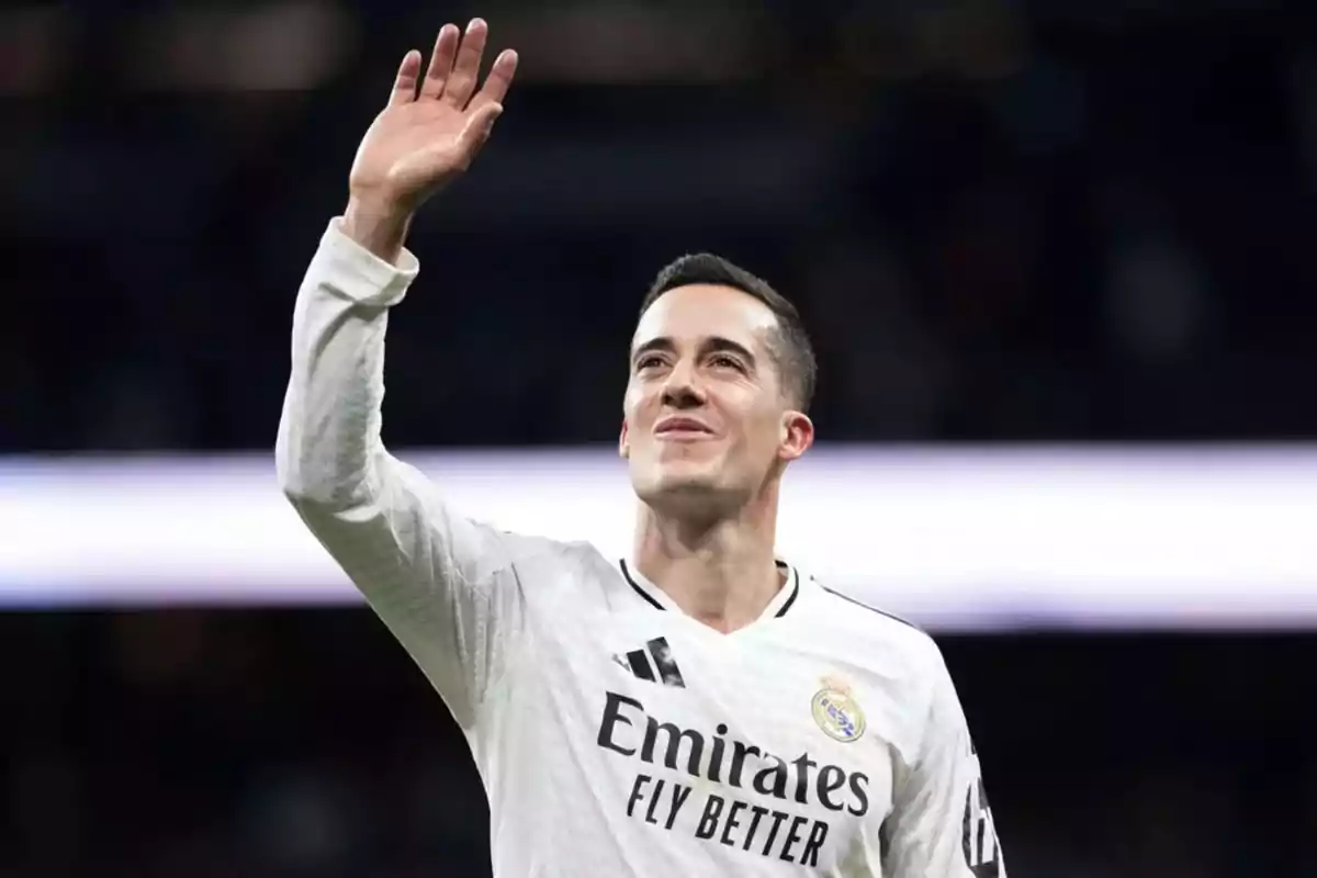 A player in a white uniform waves.