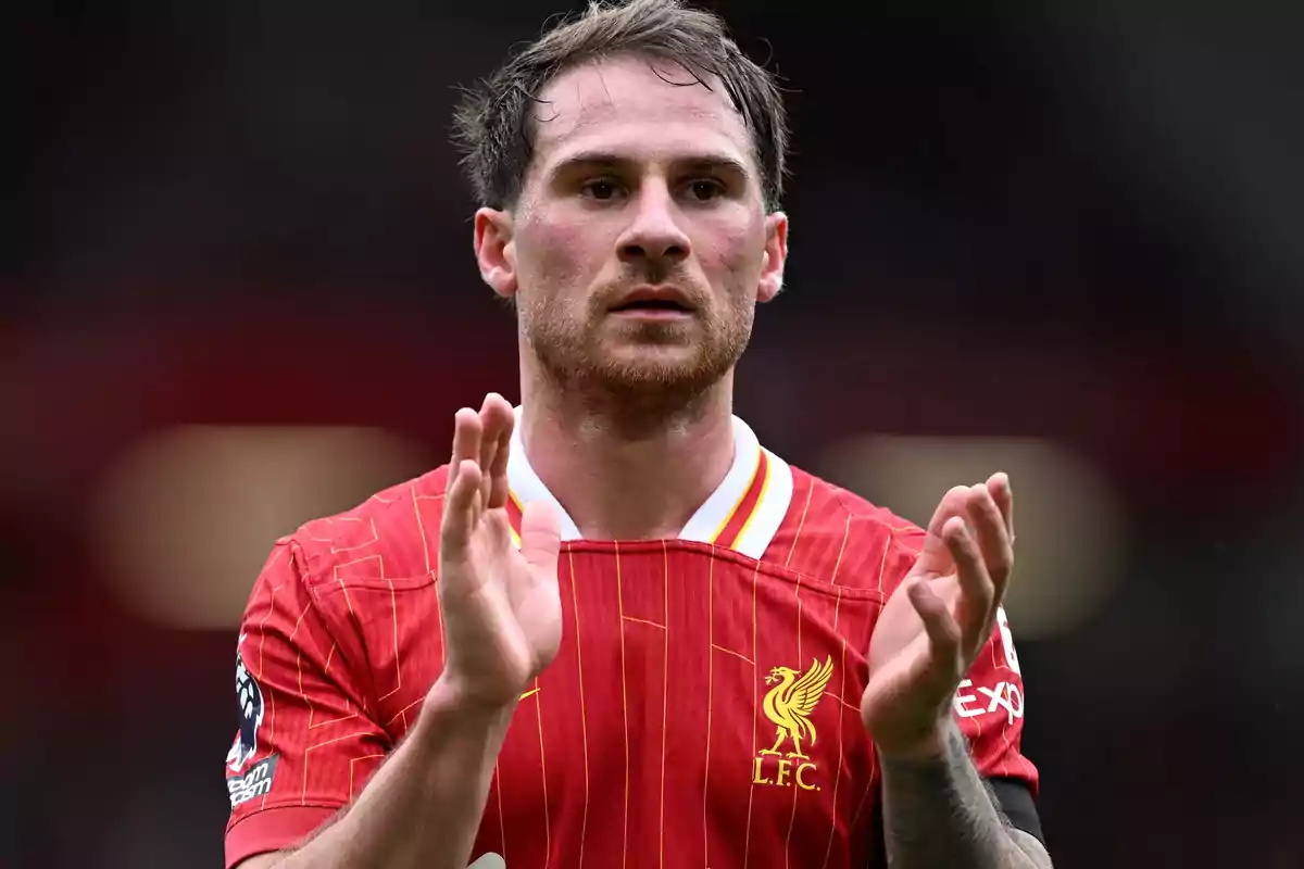 A player in a red uniform clapping on the field. A player in a red uniform clapping on the field.