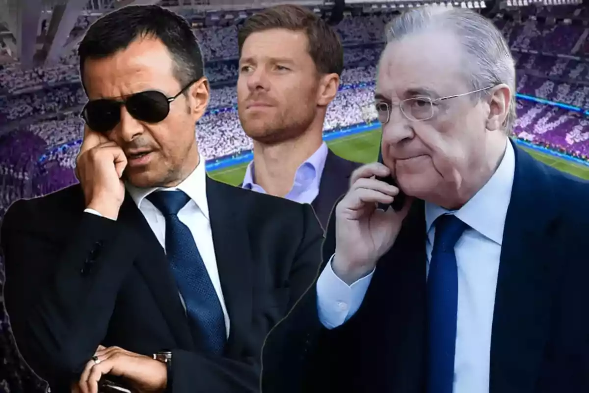 Three men in suits at a soccer stadium, two of them talking on the phone and one in the center looking straight ahead.
