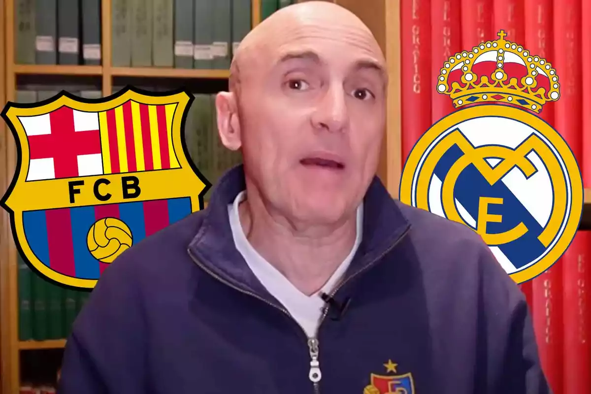 A bald man in a blue jacket is in front of a bookshelf with the crests of FC Barcelona and Real Madrid beside him.