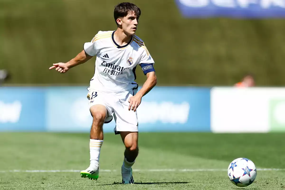Soccer player in action during a match with a white uniform and ball on the field. Soccer player in action during a match with a white uniform and ball on the field.