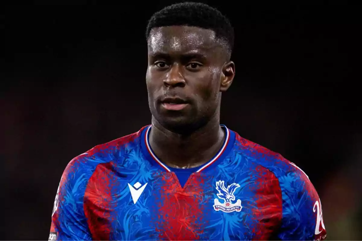 A player in a Crystal Palace uniform in a match. A player in a Crystal Palace uniform in a match.