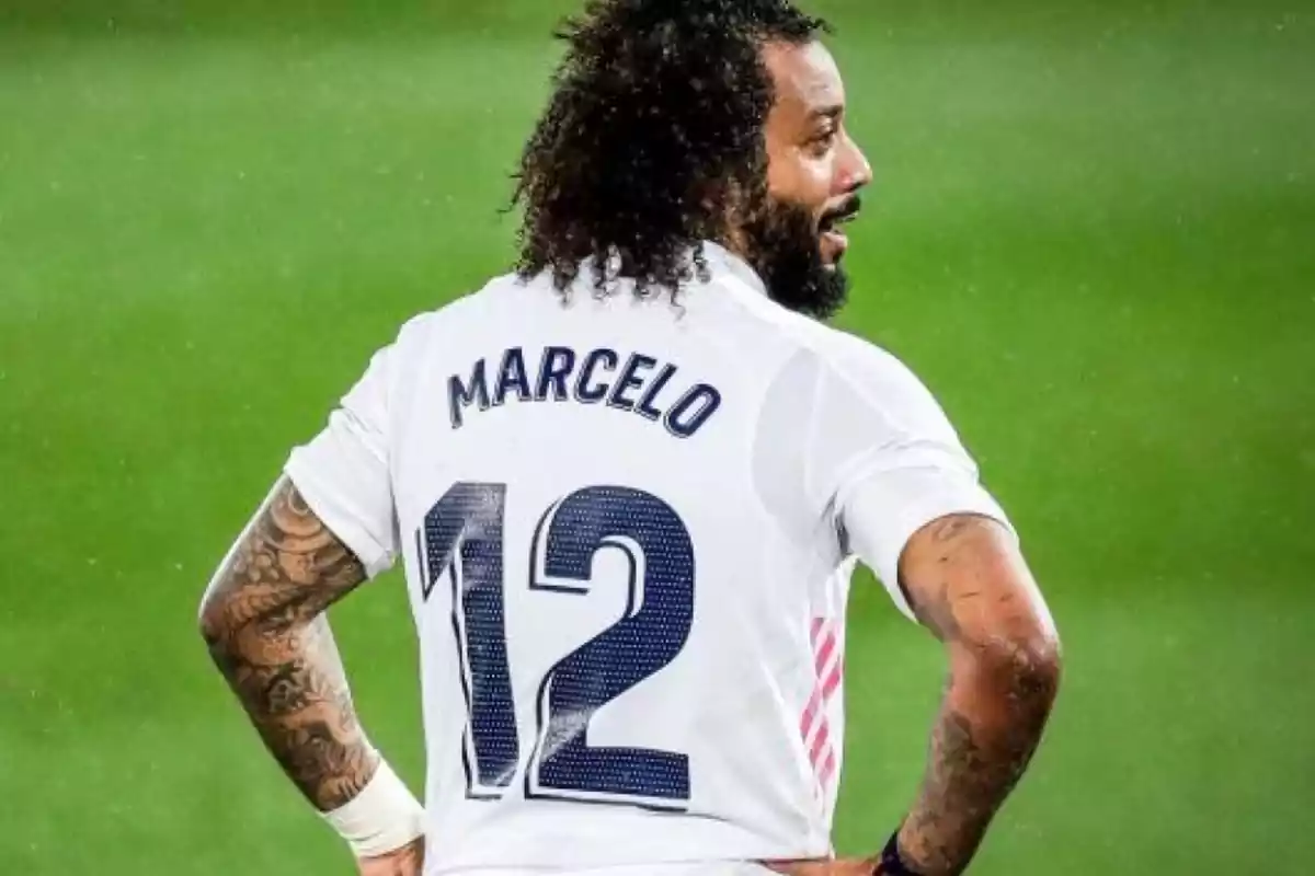 Soccer player wearing a white jersey with the number 12 on the back on a playing field Soccer player wearing a white jersey with the number 12 on the back on a playing field