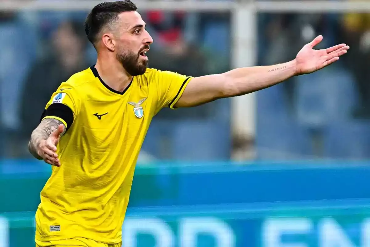 Soccer player in a yellow uniform gesturing with arms outstretched during a match Soccer player in a yellow uniform gesturing with arms outstretched during a match