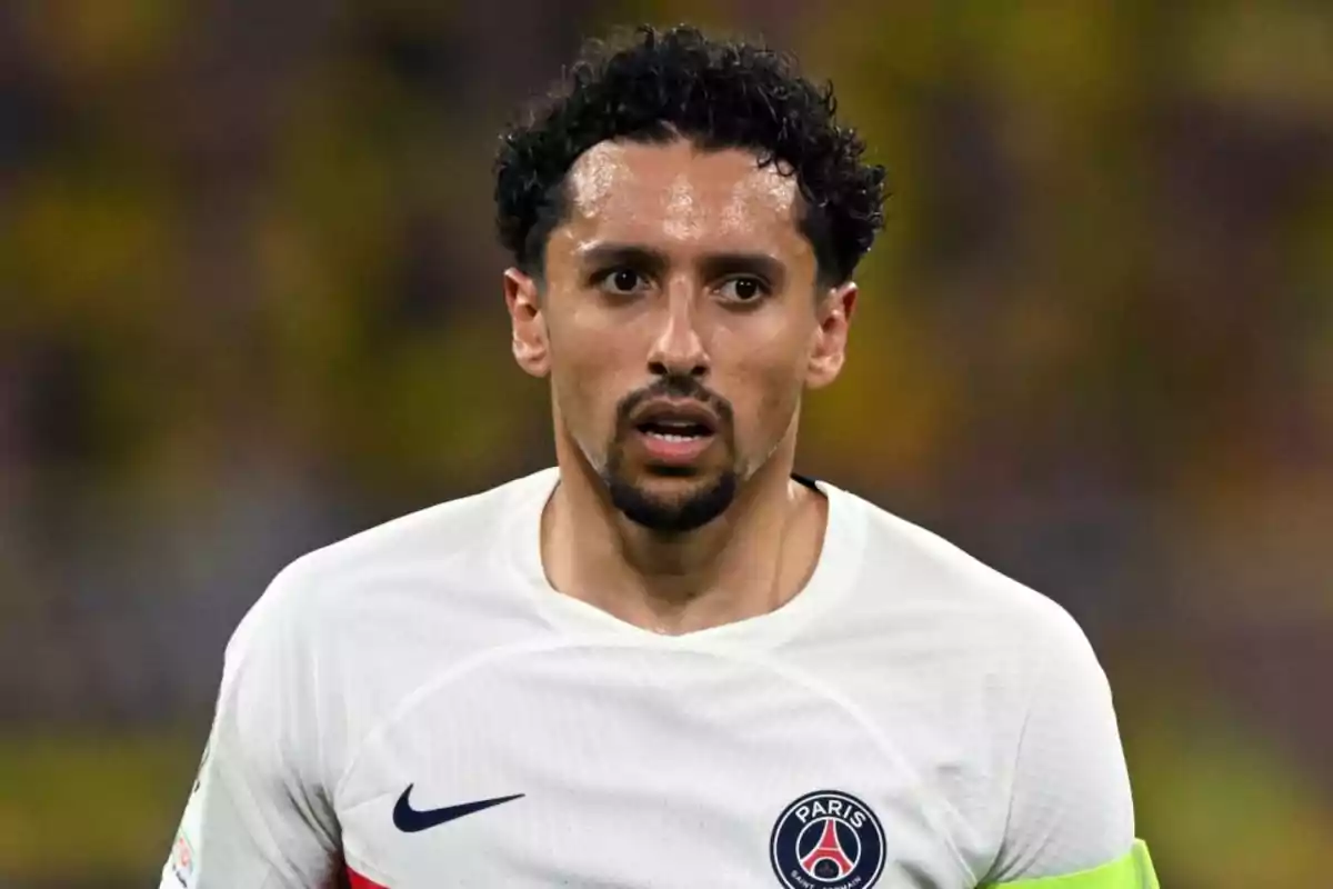 A player in a white Paris Saint-Germain jersey on the field. A player in a white Paris Saint-Germain jersey on the field.