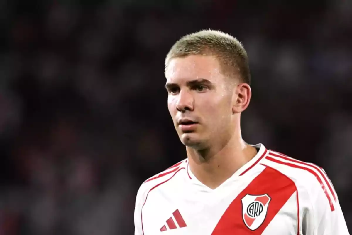 A player in a River Plate uniform on the field. A player in a River Plate uniform on the field.