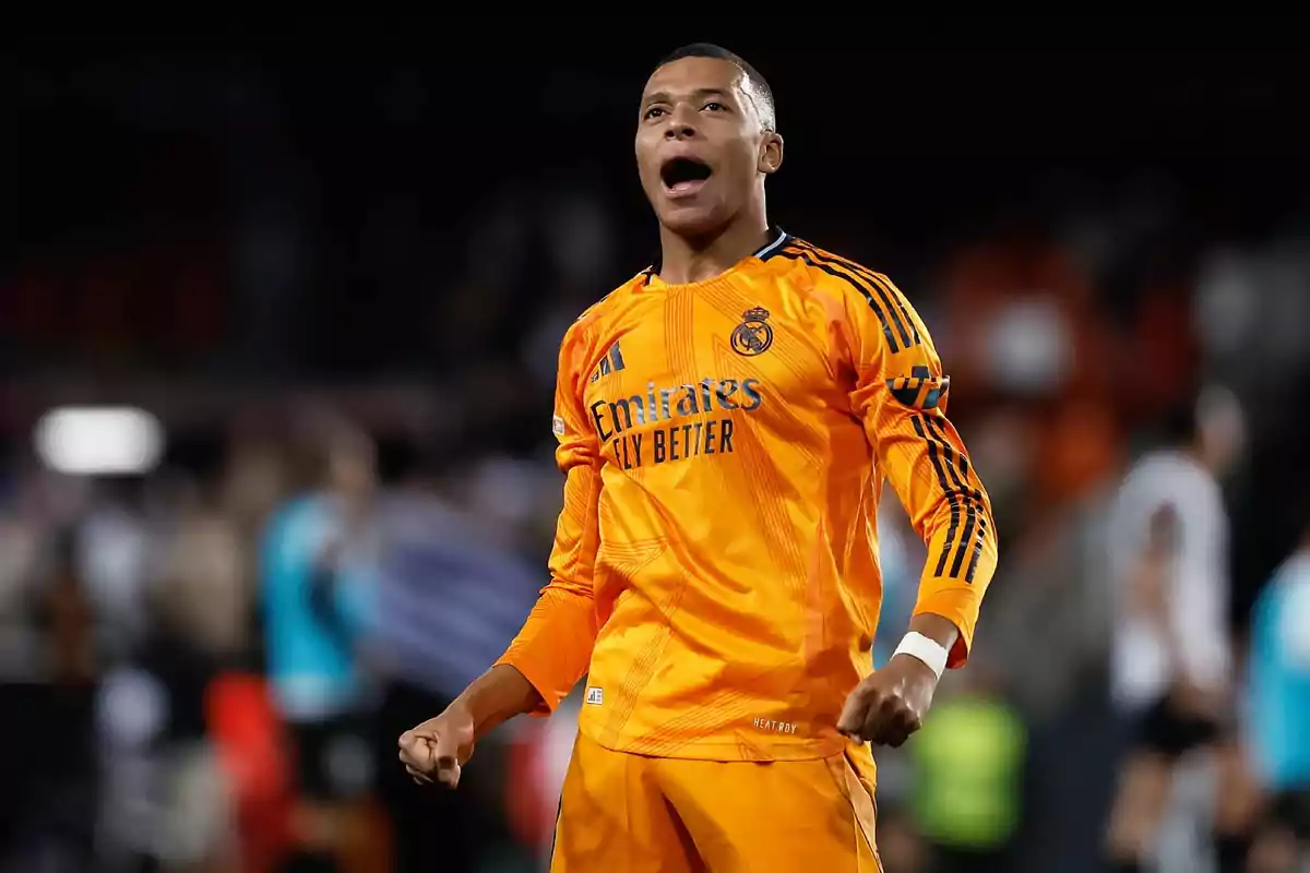 A soccer player in an orange uniform celebrates on the field. A soccer player in an orange uniform celebrates on the field.