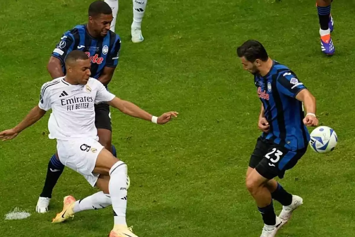 Soccer players in action during a match, one of them tries to control the ball while the other approaches to dispute the play. Soccer players in action during a match, one of them tries to control the ball while the other approaches to dispute the play.